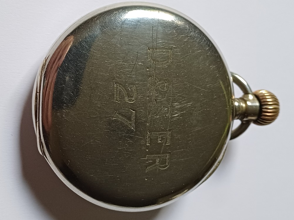 An antique open-face silver pocket watch featuring a white enamel dial with bold black Roman numerals and a subsidiary seconds dial. View VII
