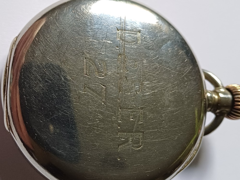 An antique open-face silver pocket watch featuring a white enamel dial with bold black Roman numerals and a subsidiary seconds dial. View IX