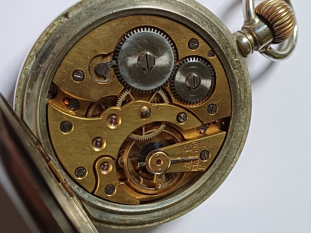 An antique open-face silver pocket watch featuring a white enamel dial with bold black Roman numerals and a subsidiary seconds dial. View XV