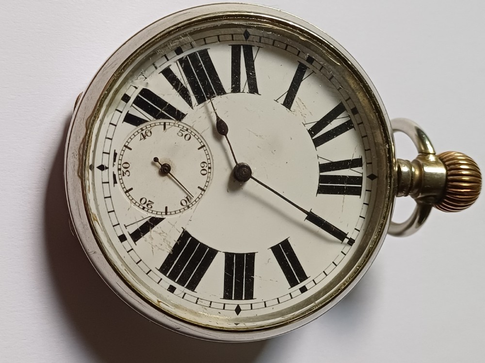 An antique open-face silver pocket watch featuring a white enamel dial with bold black Roman numerals and a subsidiary seconds dial. View XVII