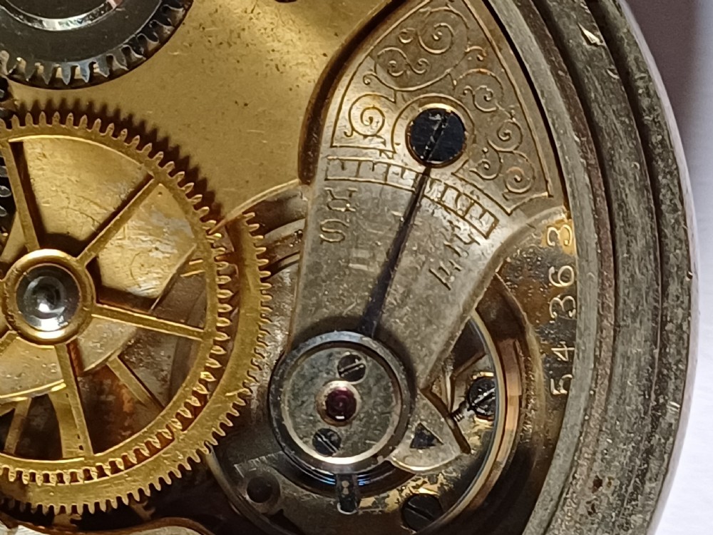 An antique First World War era military pocket watch with a white enamel dial, black Arabic numerals, and a nickel-plated metal case. View XVII