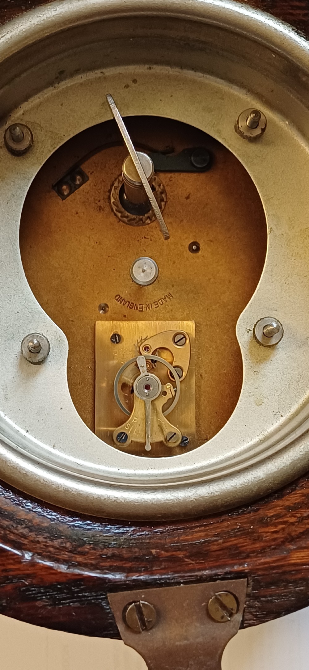 A circular dark oak GWR signal box clock featuring a brass bezel, glass face cover, cream dial with Arabic numerals, and black clock hands. View VIII