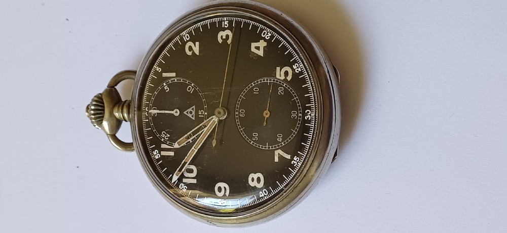 An open-face pocket watch featuring a black dial, luminescent white Arabic numerals, two sub-dials, and a silver-coloured metal case with an onion crown. View III