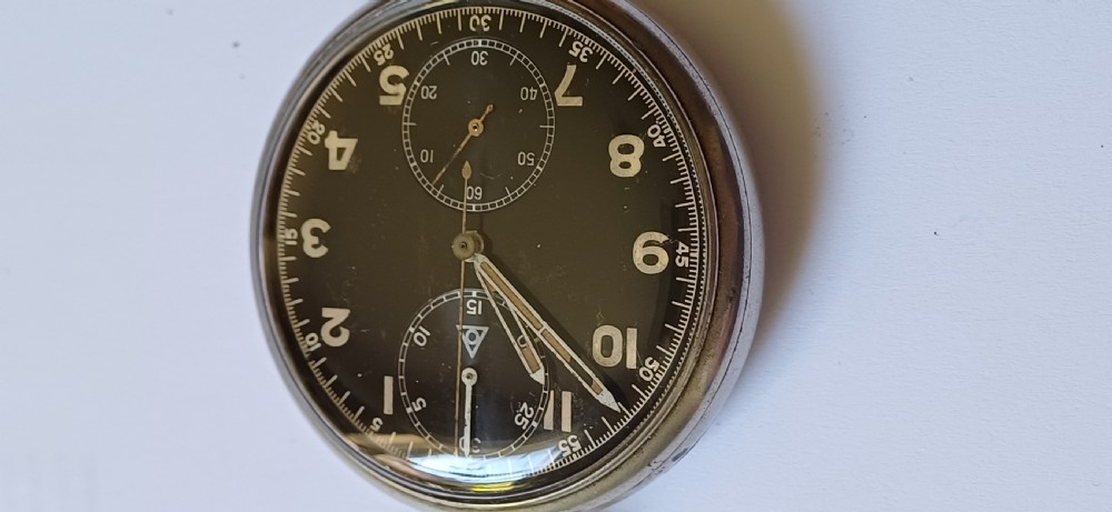 An open-face pocket watch featuring a black dial, luminescent white Arabic numerals, two sub-dials, and a silver-coloured metal case with an onion crown. View IV