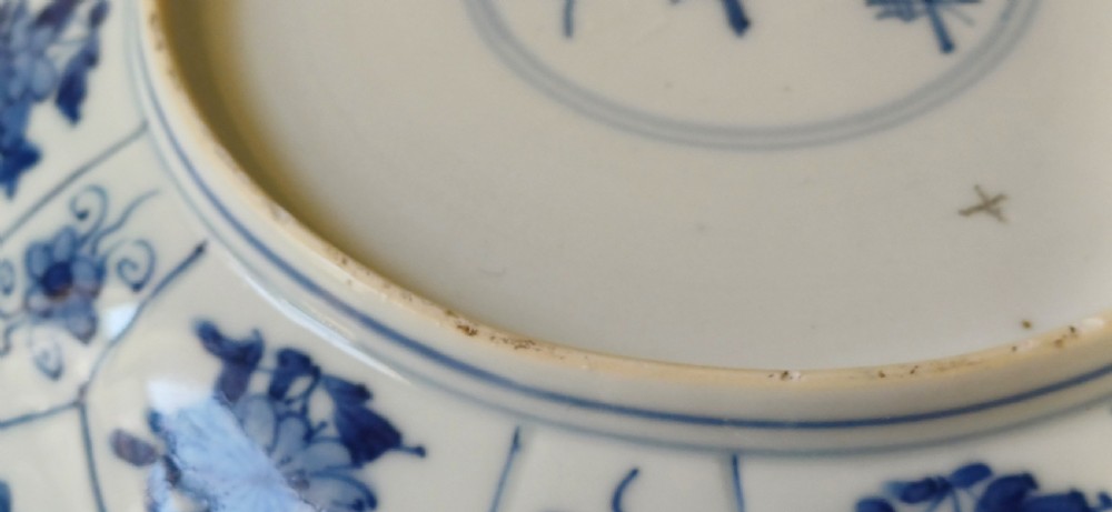 A circular Chinese porcelain dish painted with blue cobalt floral motifs, featuring a barbed rim and radiating moulded petal panels. View VIII
