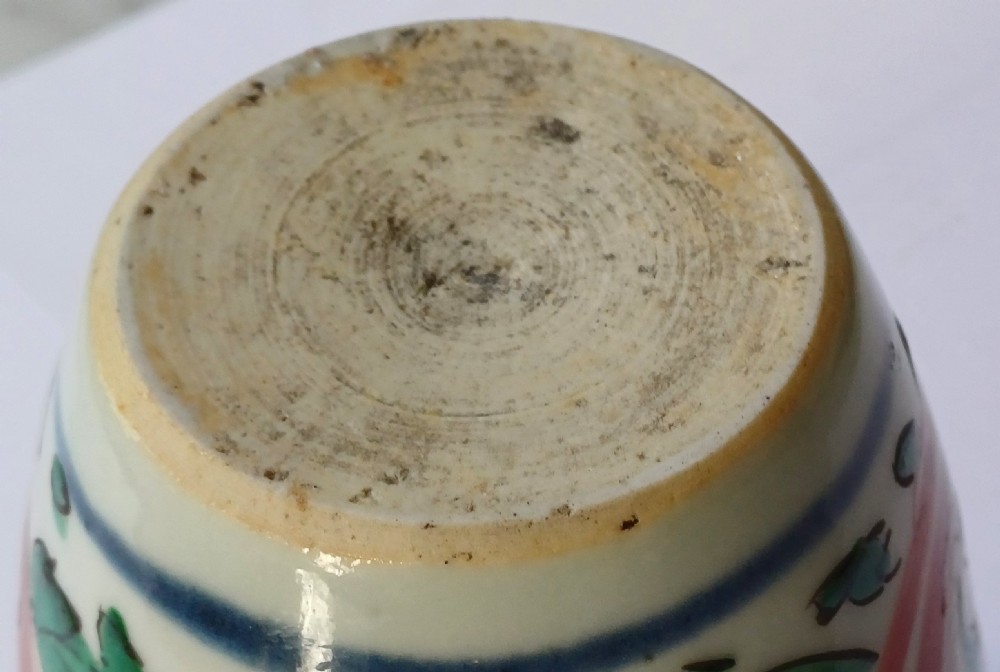 A small 17th-century Chinese Transitional Wucai porcelain jar painted with iron-red, green, and yellow Buddhistic lions amidst foliage on a white background. View VIII