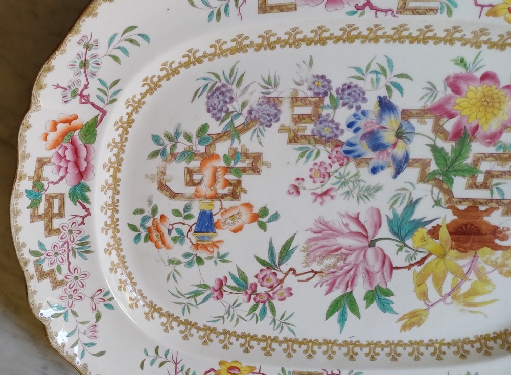 An early Victorian rectangular earthenware platter featuring hand-painted floral motifs in enamel and gilt trim on a scalloped cream ground. View III