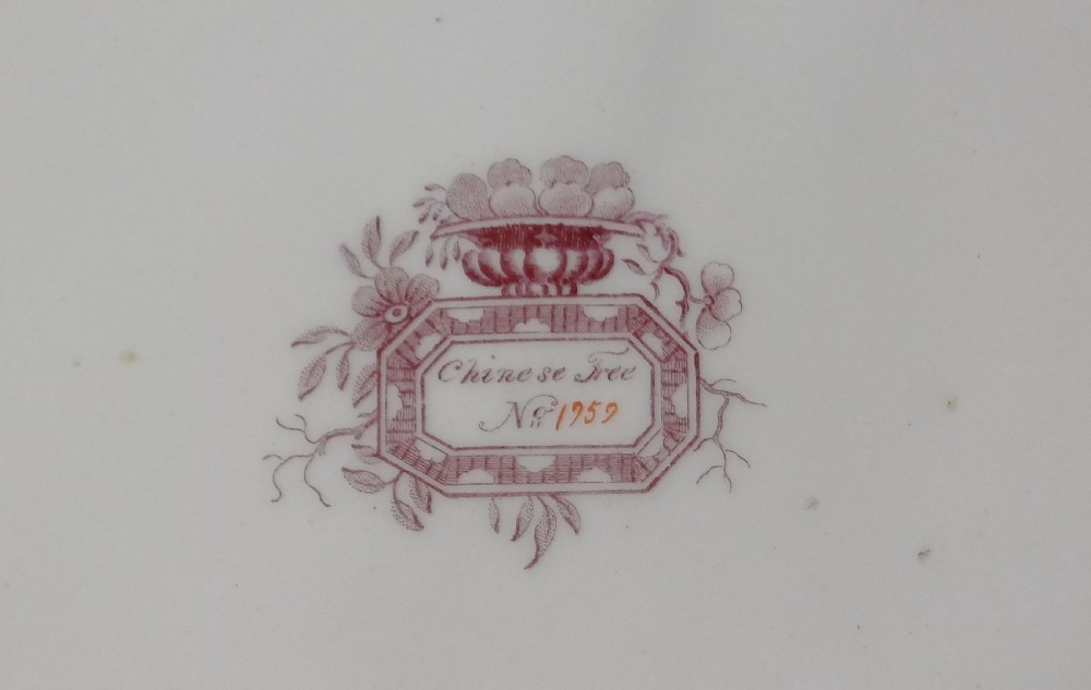 An early Victorian rectangular earthenware platter featuring hand-painted floral motifs in enamel and gilt trim on a scalloped cream ground. View VI