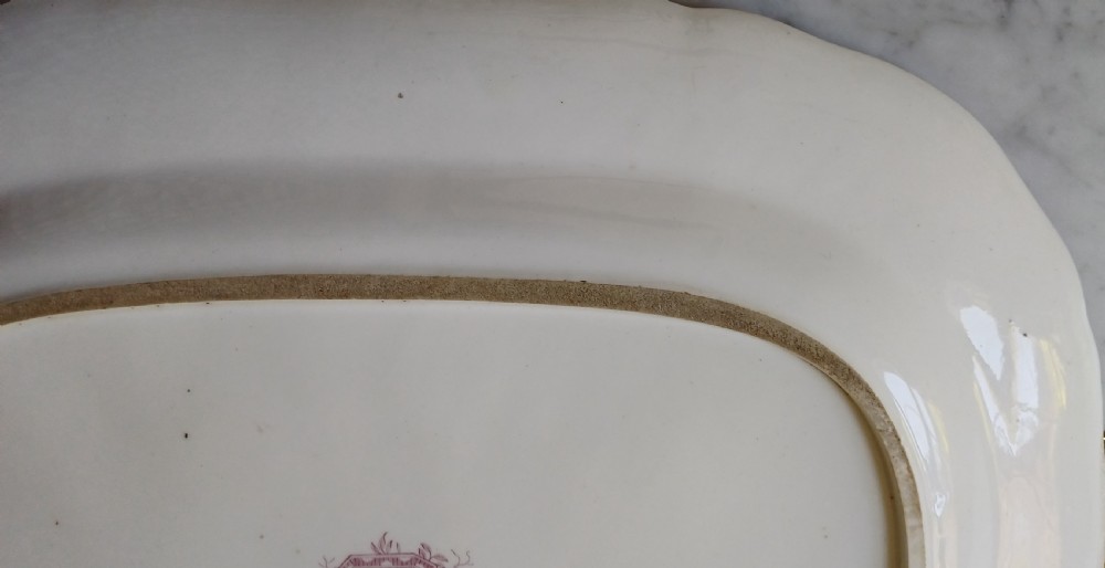 An early Victorian rectangular earthenware platter featuring hand-painted floral motifs in enamel and gilt trim on a scalloped cream ground. View VIII