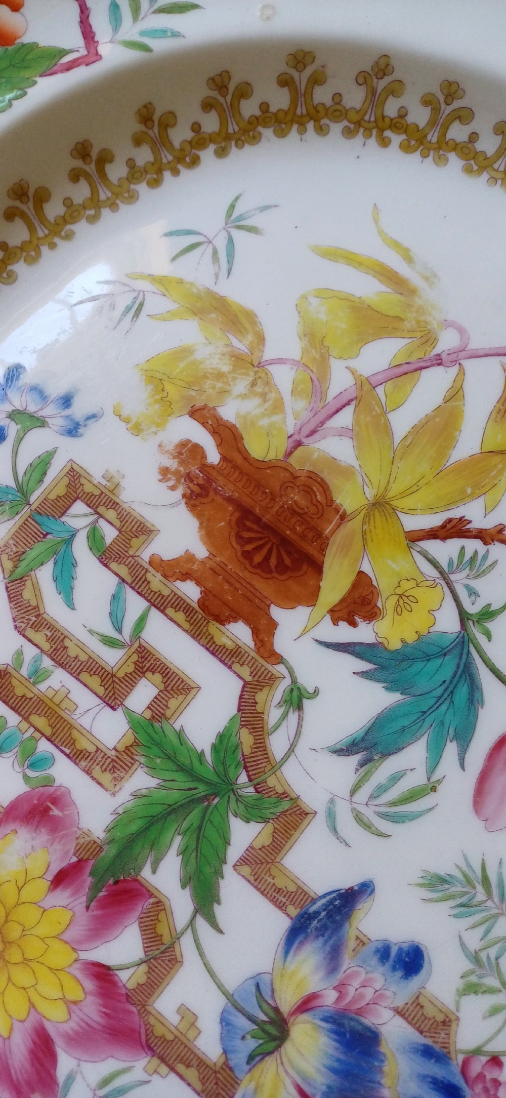 An early Victorian rectangular earthenware platter featuring hand-painted floral motifs in enamel and gilt trim on a scalloped cream ground. View XIV