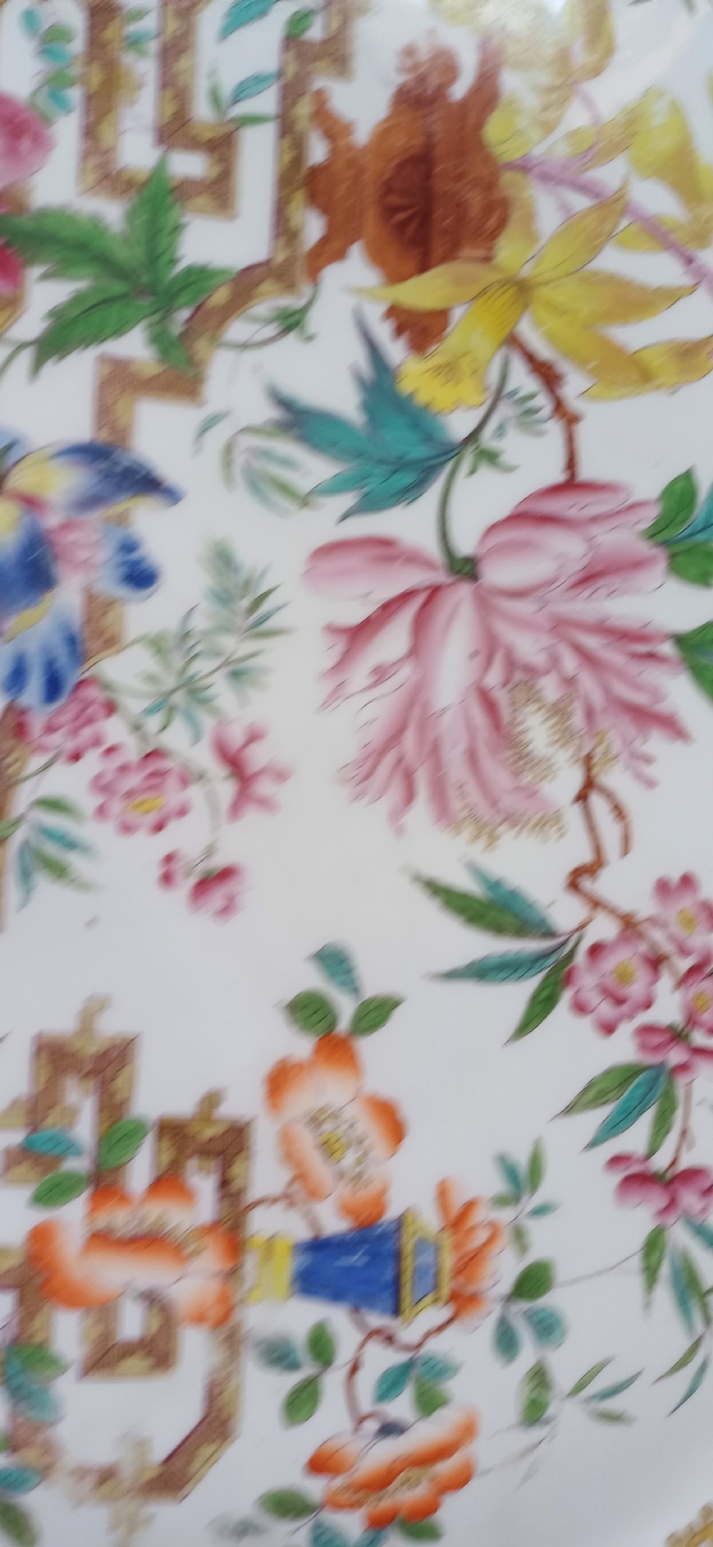 An early Victorian rectangular earthenware platter featuring hand-painted floral motifs in enamel and gilt trim on a scalloped cream ground. View XV
