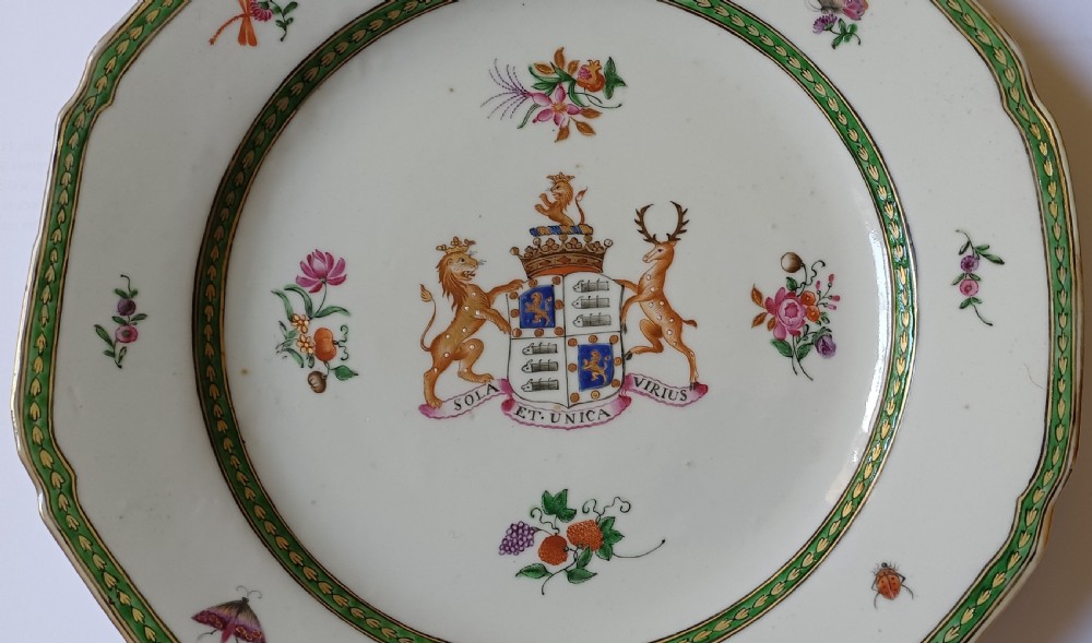 An octagonal 18th-century Chinese export porcelain plate decorated with a central heraldic coat of arms, floral sprays, and a green patterned border. View II