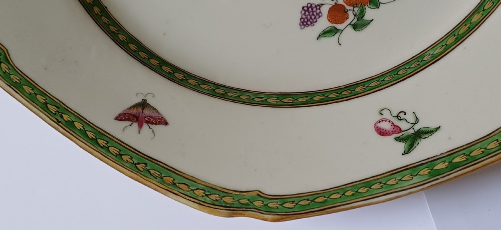 An octagonal 18th-century Chinese export porcelain plate decorated with a central heraldic coat of arms, floral sprays, and a green patterned border. View VIII