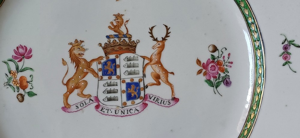 An octagonal 18th-century Chinese export porcelain plate decorated with a central heraldic coat of arms, floral sprays, and a green patterned border. View XI