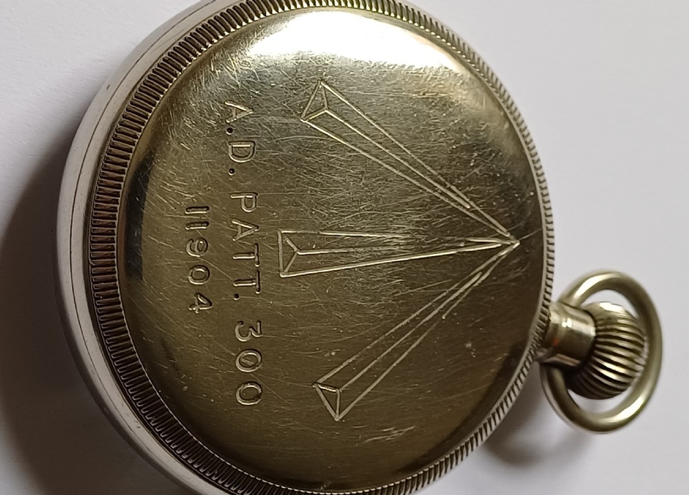 An open-face WW2 military pocket watch featuring a white enamel dial with Roman numerals, a subsidiary seconds dial, and a coin-edge bezel. View VIII
