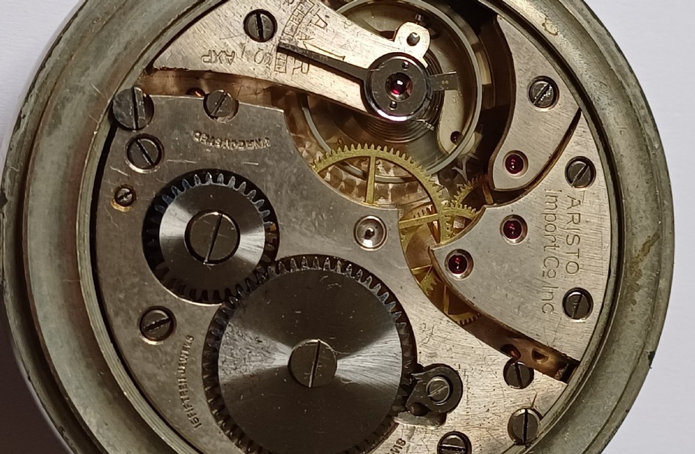 An open-face WW2 military pocket watch featuring a white enamel dial with Roman numerals, a subsidiary seconds dial, and a coin-edge bezel. View XIV