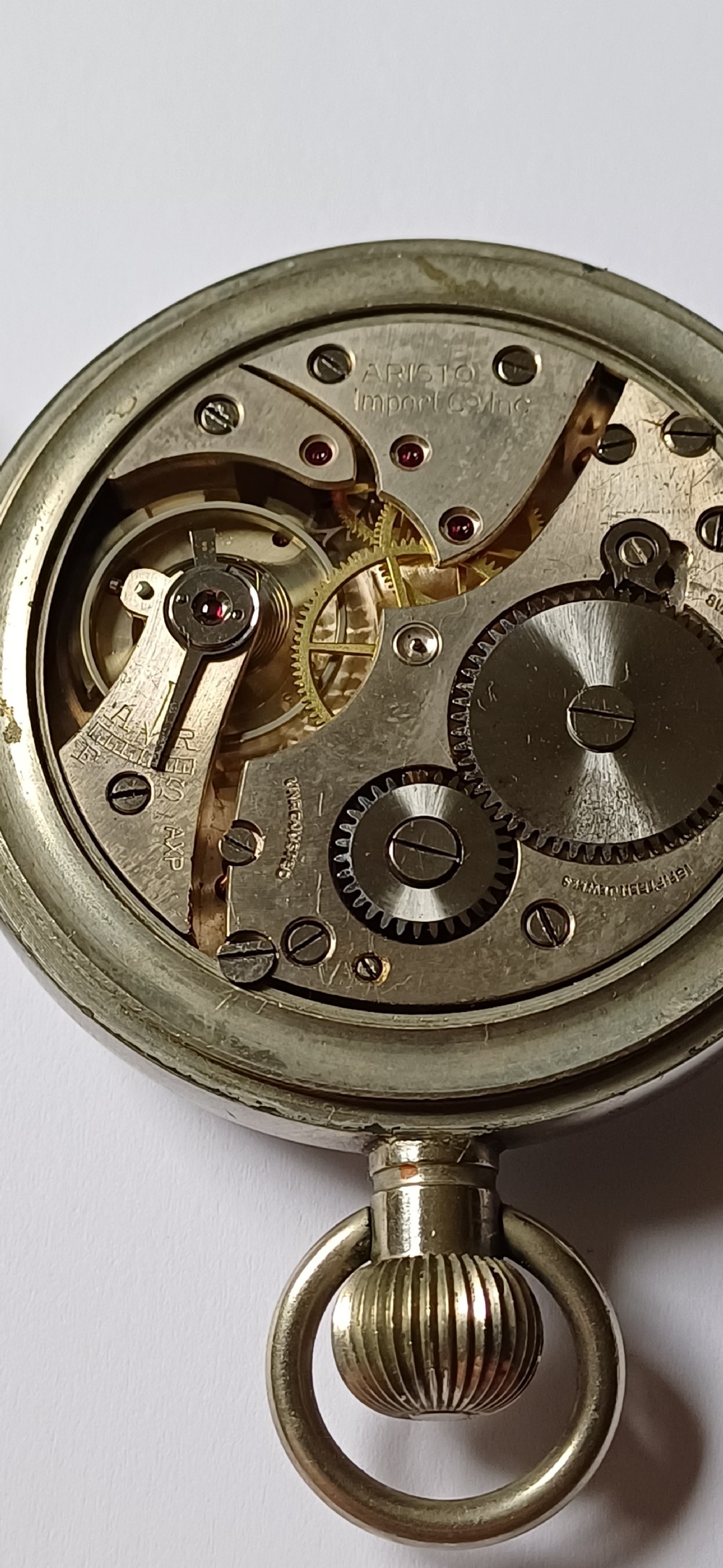An open-face WW2 military pocket watch featuring a white enamel dial with Roman numerals, a subsidiary seconds dial, and a coin-edge bezel. View XVI