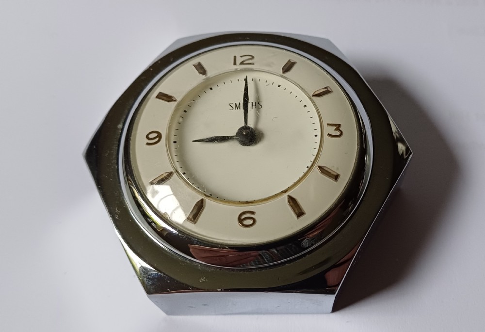 (Reserved EK) A fantastic small Smiths desk clock in the design of a motoring hexagonal wheel nut, as designed for a set of sports car wire wheels, dating circa 1940’s  View II