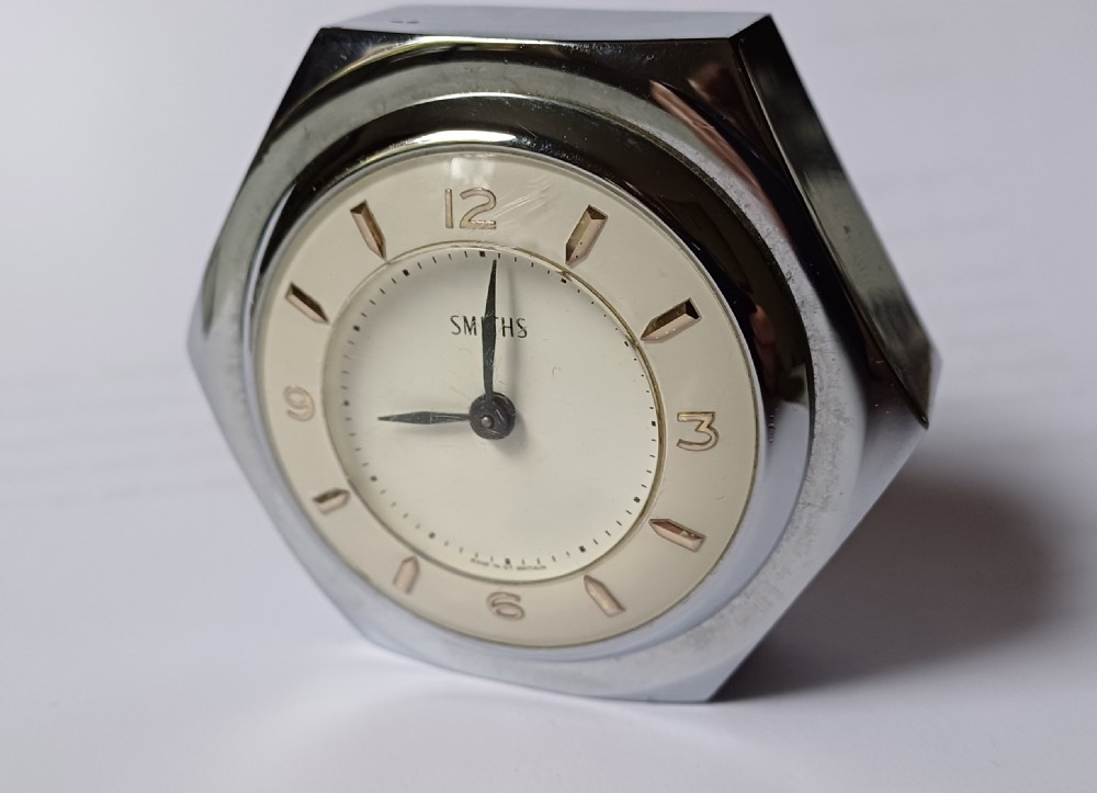 (Reserved EK) A fantastic small Smiths desk clock in the design of a motoring hexagonal wheel nut, as designed for a set of sports car wire wheels, dating circa 1940’s  View III