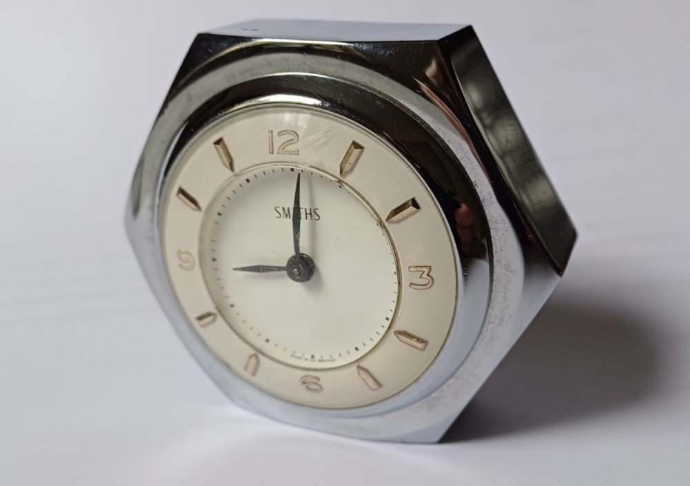 (Reserved EK) A fantastic small Smiths desk clock in the design of a motoring hexagonal wheel nut, as designed for a set of sports car wire wheels, dating circa 1940’s  View IV
