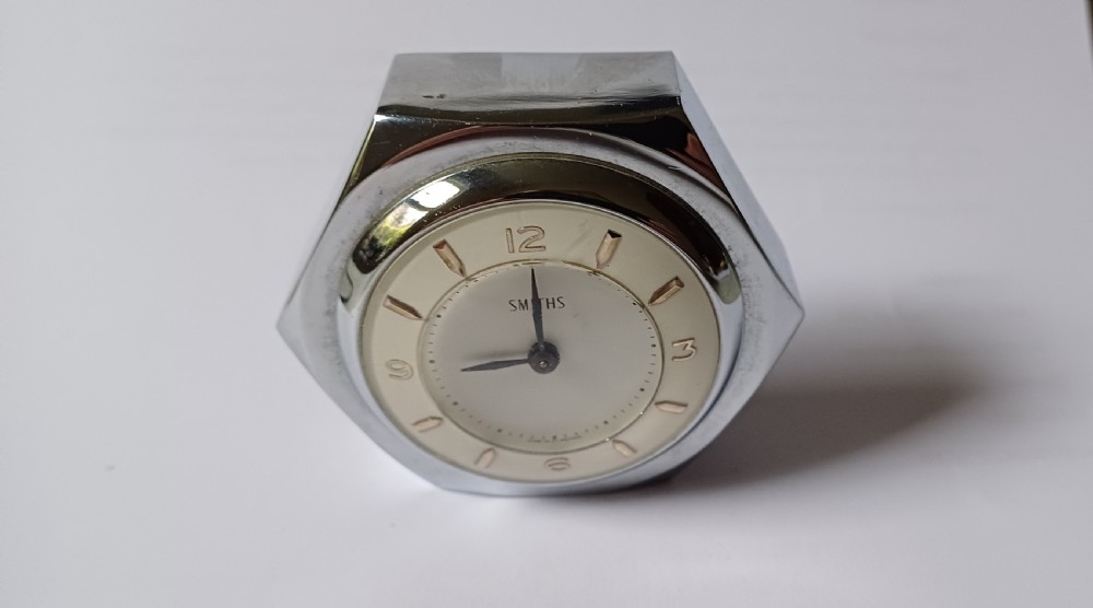 (Reserved EK) A fantastic small Smiths desk clock in the design of a motoring hexagonal wheel nut, as designed for a set of sports car wire wheels, dating circa 1940’s  View VI