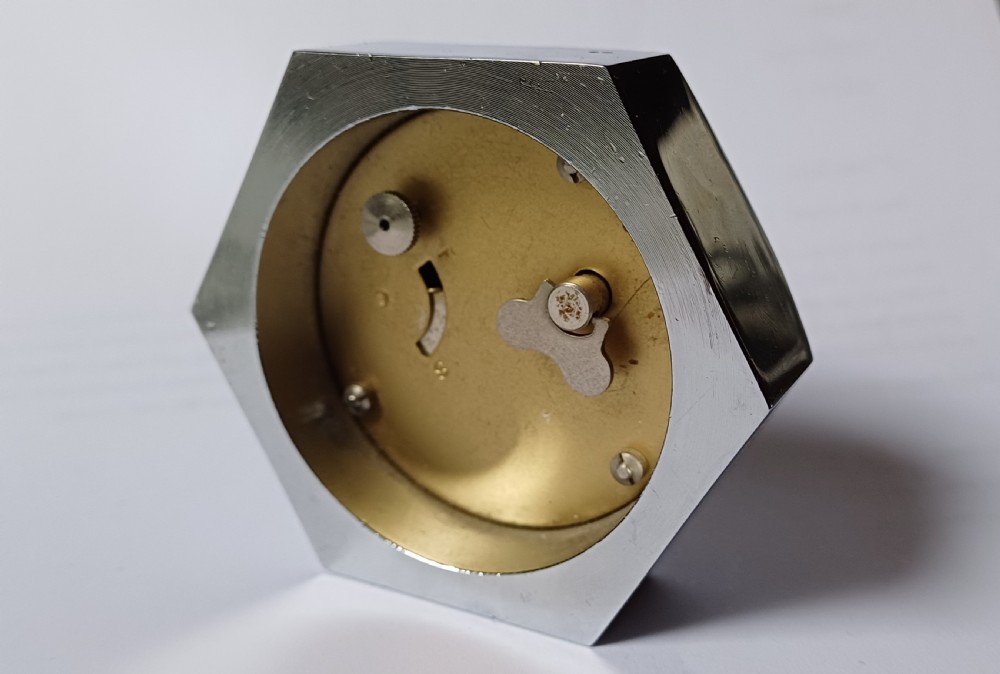 (Reserved EK) A fantastic small Smiths desk clock in the design of a motoring hexagonal wheel nut, as designed for a set of sports car wire wheels, dating circa 1940’s  View XIII