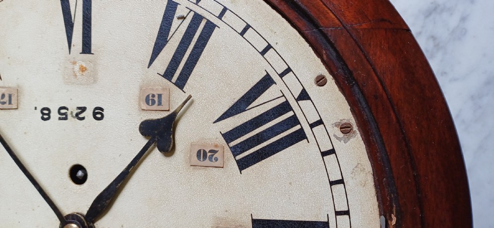 An early 20th-century round mahogany railway wall clock featuring an off-white dial with Roman numerals, secondary 24-hour markings, and B.R.(E.) lettering. View IV