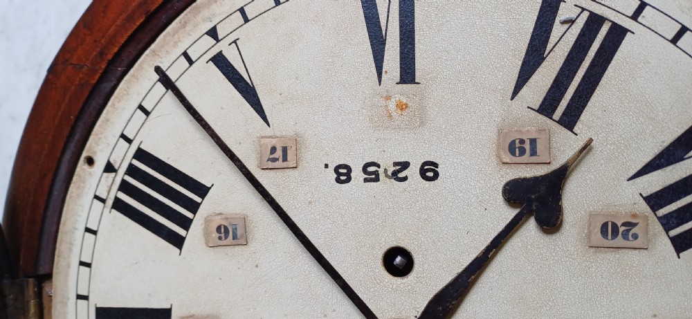 An early 20th-century round mahogany railway wall clock featuring an off-white dial with Roman numerals, secondary 24-hour markings, and B.R.(E.) lettering. View X