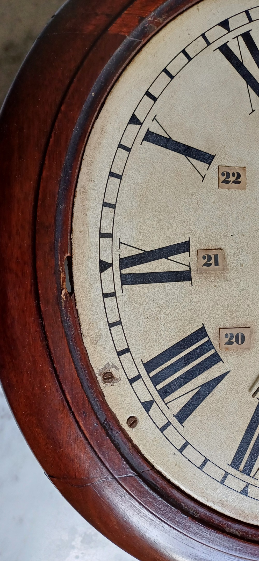 An early 20th-century round mahogany railway wall clock featuring an off-white dial with Roman numerals, secondary 24-hour markings, and B.R.(E.) lettering. View XII
