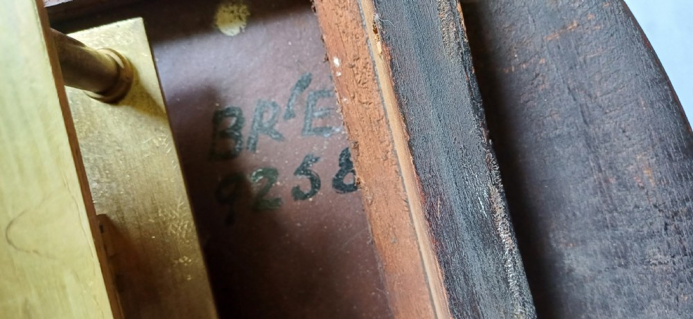 An early 20th-century round mahogany railway wall clock featuring an off-white dial with Roman numerals, secondary 24-hour markings, and B.R.(E.) lettering. View XV