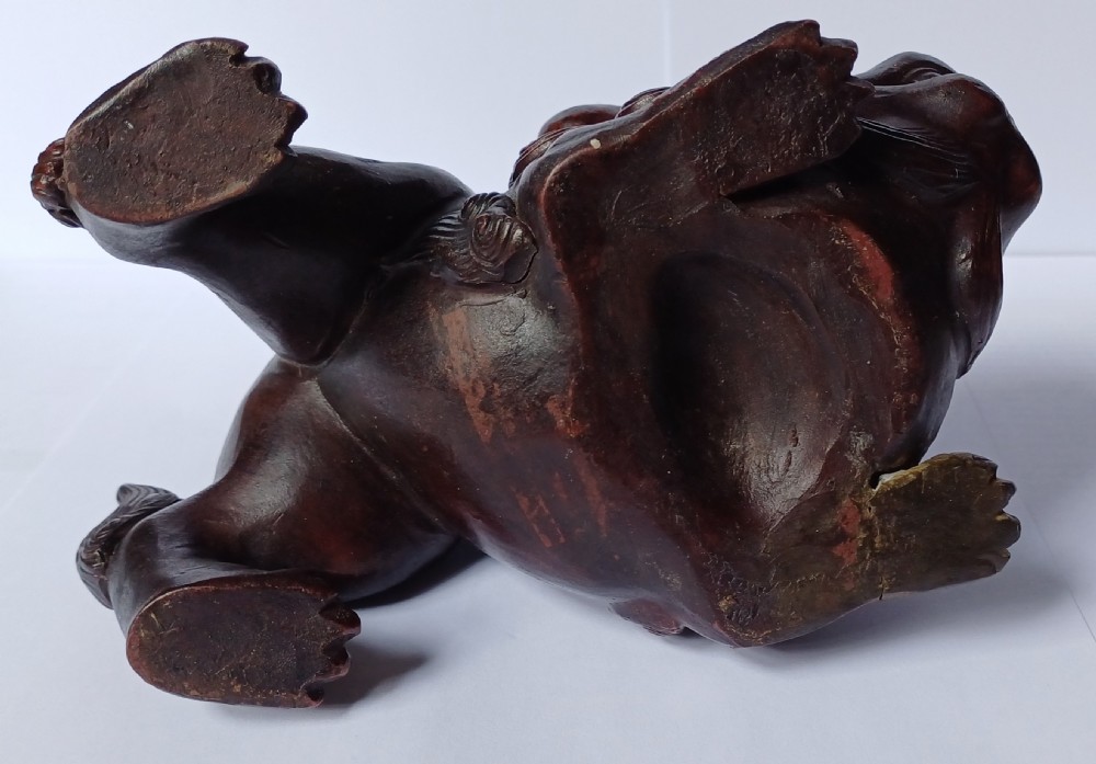 A dark brown Japanese Bizen stoneware Shishi lion dog sculpture with swirling carved details on its mane and tail. View XI