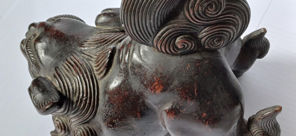 A dark brown Japanese Bizen stoneware Shishi lion dog sculpture with swirling carved details on its mane and tail. View XIV