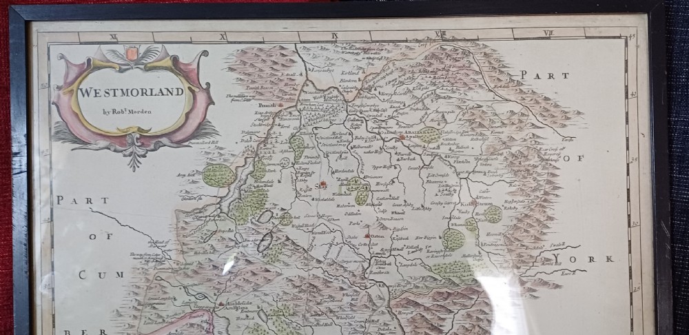 An 18th-century framed copperplate map of Westmorland by Robert Morden with hand-coloured details and a decorative cartouche. View III