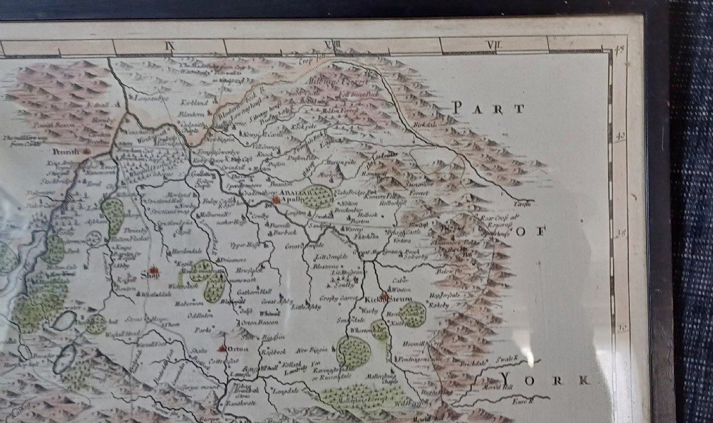 An 18th-century framed copperplate map of Westmorland by Robert Morden with hand-coloured details and a decorative cartouche. View IV