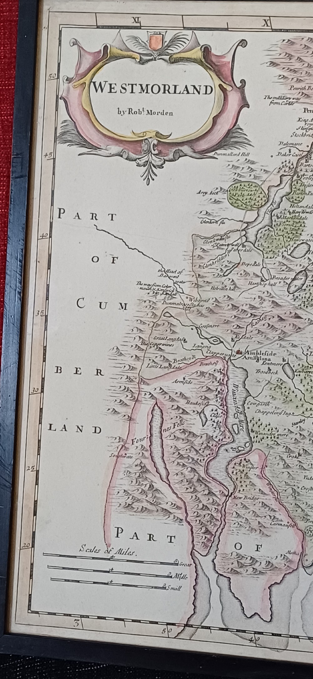 An 18th-century framed copperplate map of Westmorland by Robert Morden with hand-coloured details and a decorative cartouche. View IX