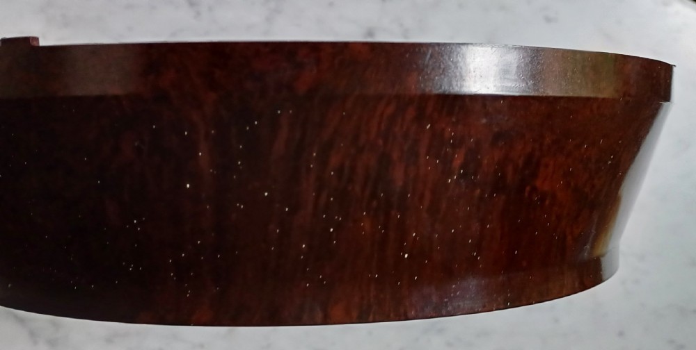 A circular mid-century wall clock featuring a moulded dark brown Bakelite case, a white dial with black Arabic numerals, and dark hands. View XXII