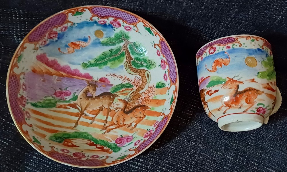 A circular 18th-century Chinese export porcelain saucer hand-painted with deer, a pine tree, and a flying bat motif within a purple lattice border. View II