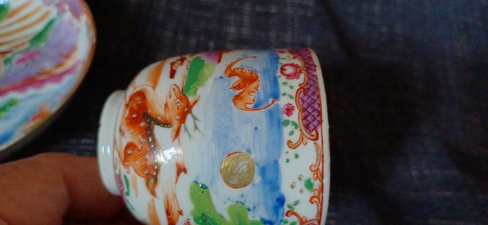A circular 18th-century Chinese export porcelain saucer hand-painted with deer, a pine tree, and a flying bat motif within a purple lattice border. View XIII