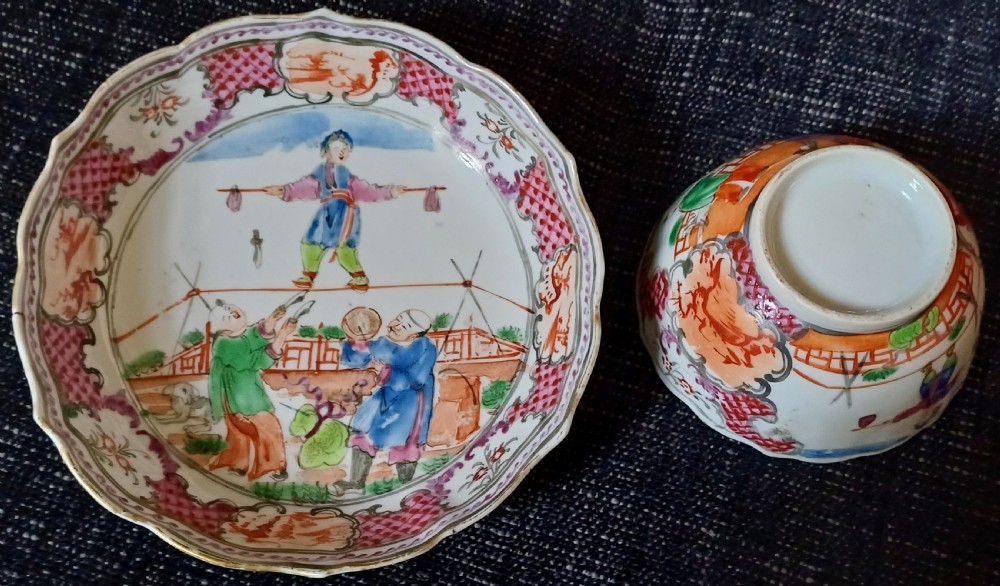 An 18th-century Chinese Mandarin palette porcelain tea bowl and saucer decorated with hand-painted acrobatic figures and pink diaper borders. View II
