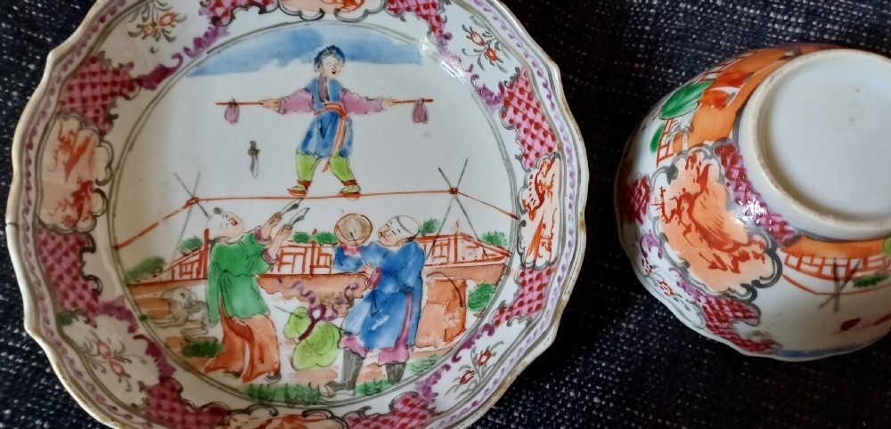 An 18th-century Chinese Mandarin palette porcelain tea bowl and saucer decorated with hand-painted acrobatic figures and pink diaper borders. View III