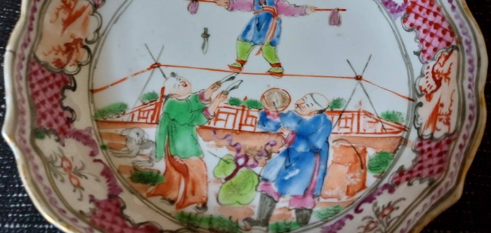 An 18th-century Chinese Mandarin palette porcelain tea bowl and saucer decorated with hand-painted acrobatic figures and pink diaper borders. View XI