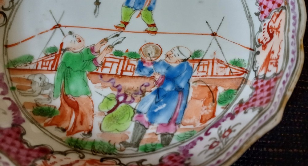 An 18th-century Chinese Mandarin palette porcelain tea bowl and saucer decorated with hand-painted acrobatic figures and pink diaper borders. View XII