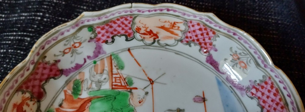 An 18th-century Chinese Mandarin palette porcelain tea bowl and saucer decorated with hand-painted acrobatic figures and pink diaper borders. View XIV