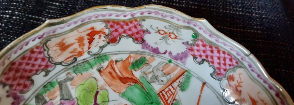 An 18th-century Chinese Mandarin palette porcelain tea bowl and saucer decorated with hand-painted acrobatic figures and pink diaper borders. View XV