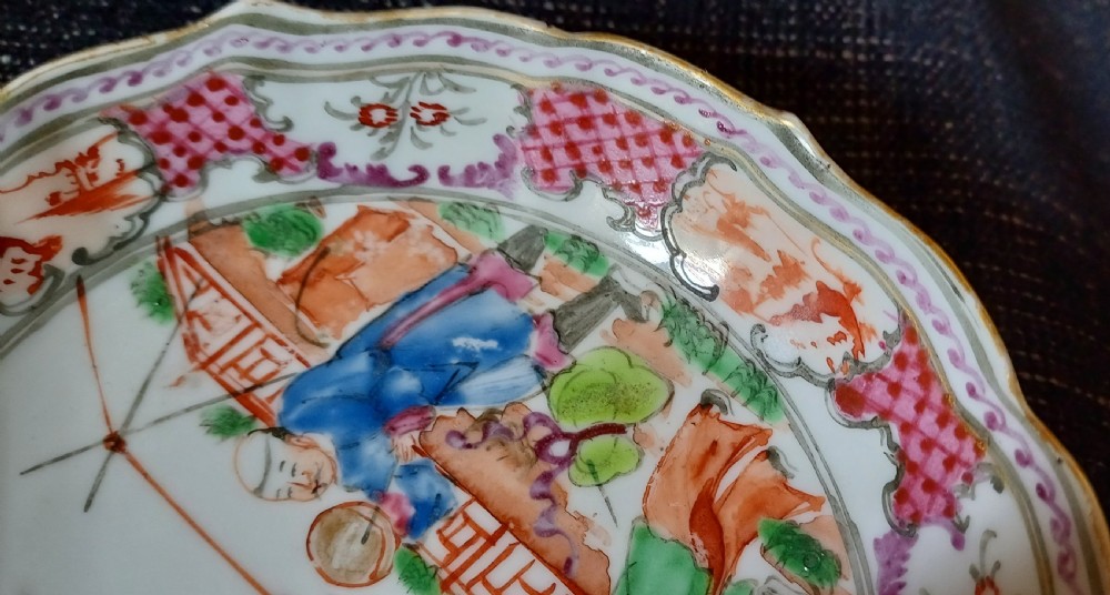 An 18th-century Chinese Mandarin palette porcelain tea bowl and saucer decorated with hand-painted acrobatic figures and pink diaper borders. View XVI