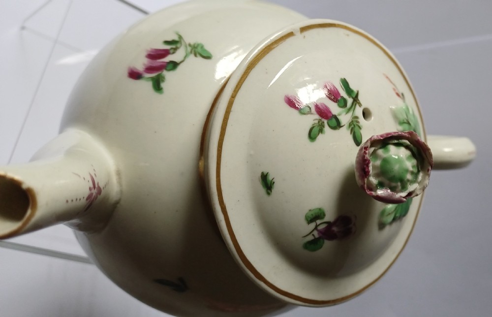 An 18th-century Dr Wall period Worcester porcelain teapot featuring hand-painted floral sprays, a loop handle, and a floral knop lid. View VIII