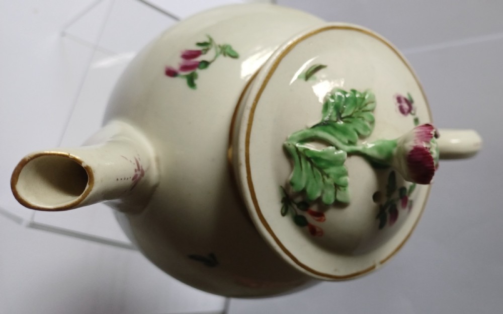 An 18th-century Dr Wall period Worcester porcelain teapot featuring hand-painted floral sprays, a loop handle, and a floral knop lid. View XXI