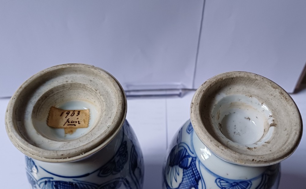 A pair of antique Chinese Kangxi period ovoid porcelain jars with fitted lids, decorated with hand-painted cobalt blue floral motifs on a white background. View IV