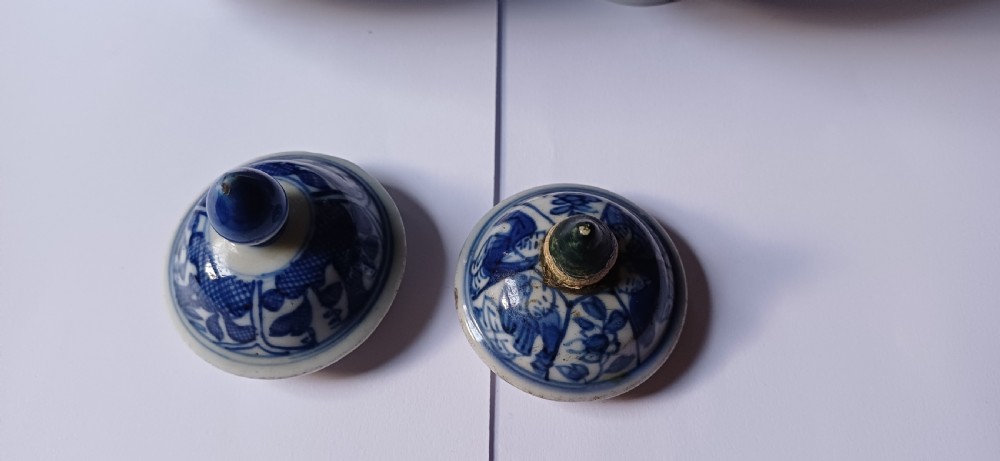 A pair of antique Chinese Kangxi period ovoid porcelain jars with fitted lids, decorated with hand-painted cobalt blue floral motifs on a white background. View VII