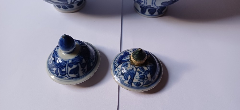 A pair of antique Chinese Kangxi period ovoid porcelain jars with fitted lids, decorated with hand-painted cobalt blue floral motifs on a white background. View VIII